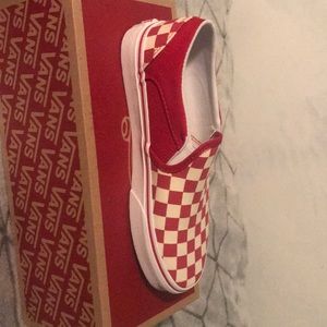 Red and white low top checkered vans